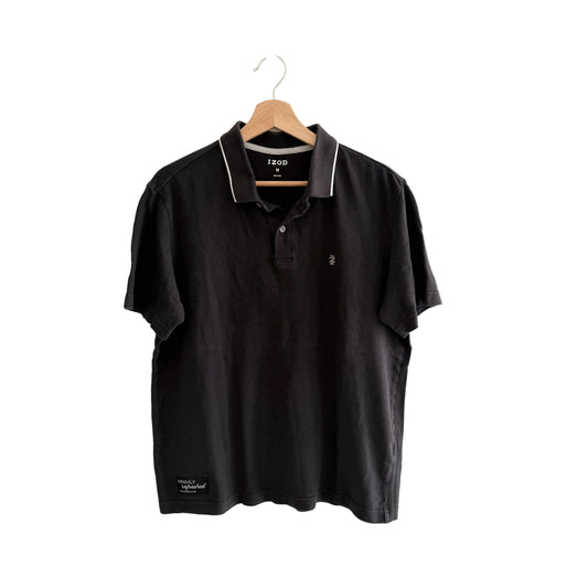 Black polo shirt on a hanger against a white background