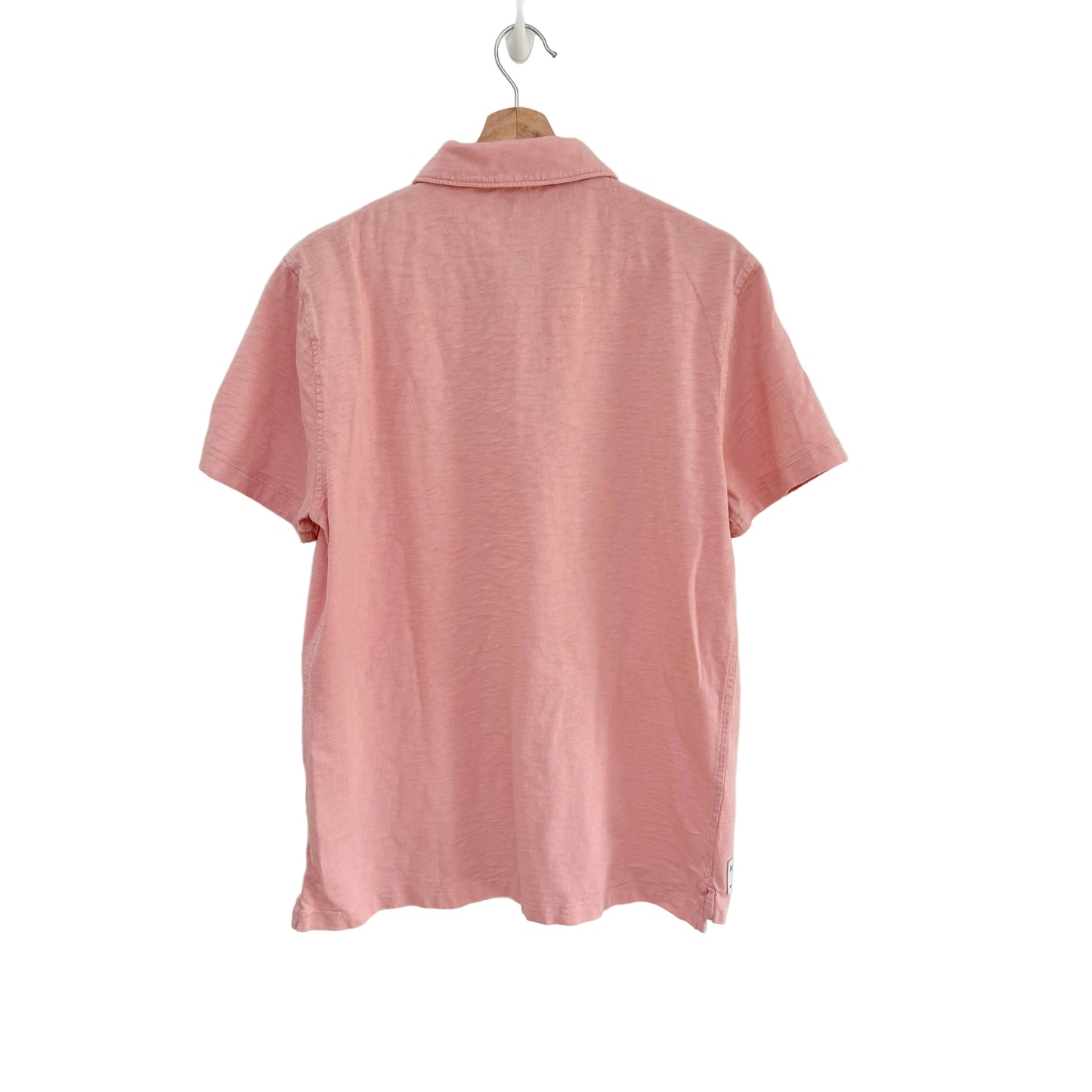 Pink shirt on a hanger against a white background
