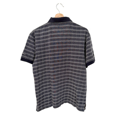Plaid shirt on a hanger against a white background