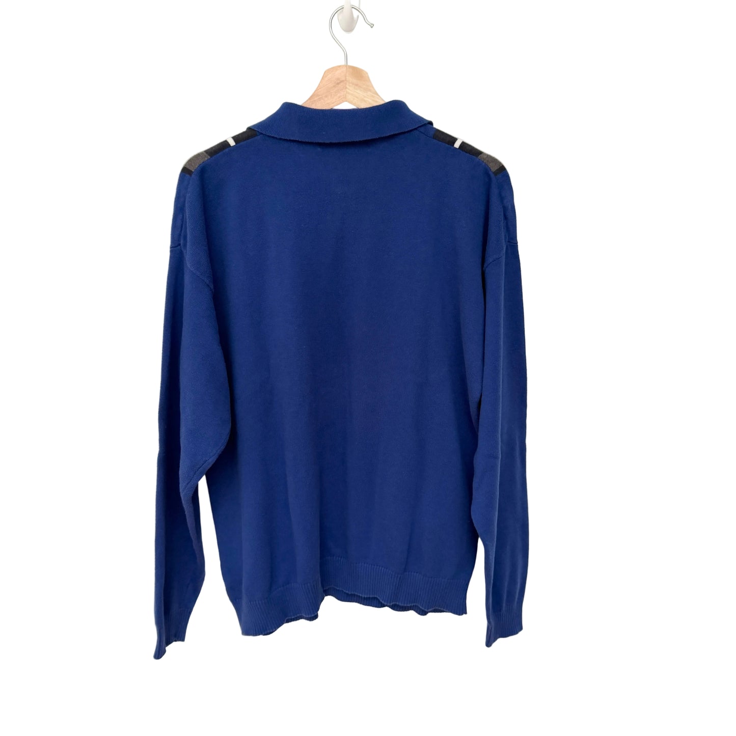 Blue sweater with black accents on a hanger against a white background