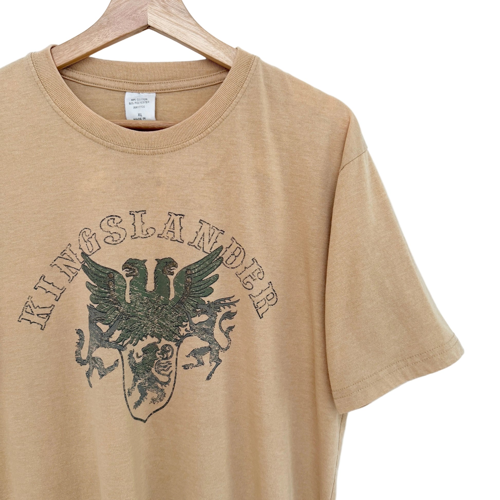 Beige t-shirt with 'Kingslander' logo on a hanger against a white background