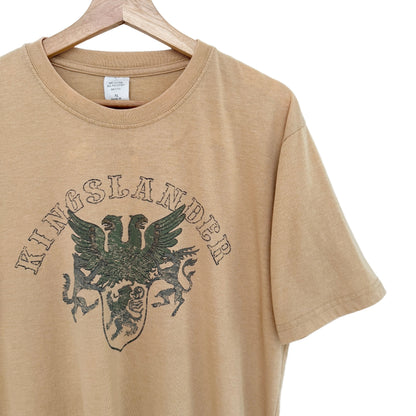 Beige t-shirt with 'Kingslander' logo on a hanger against a white background