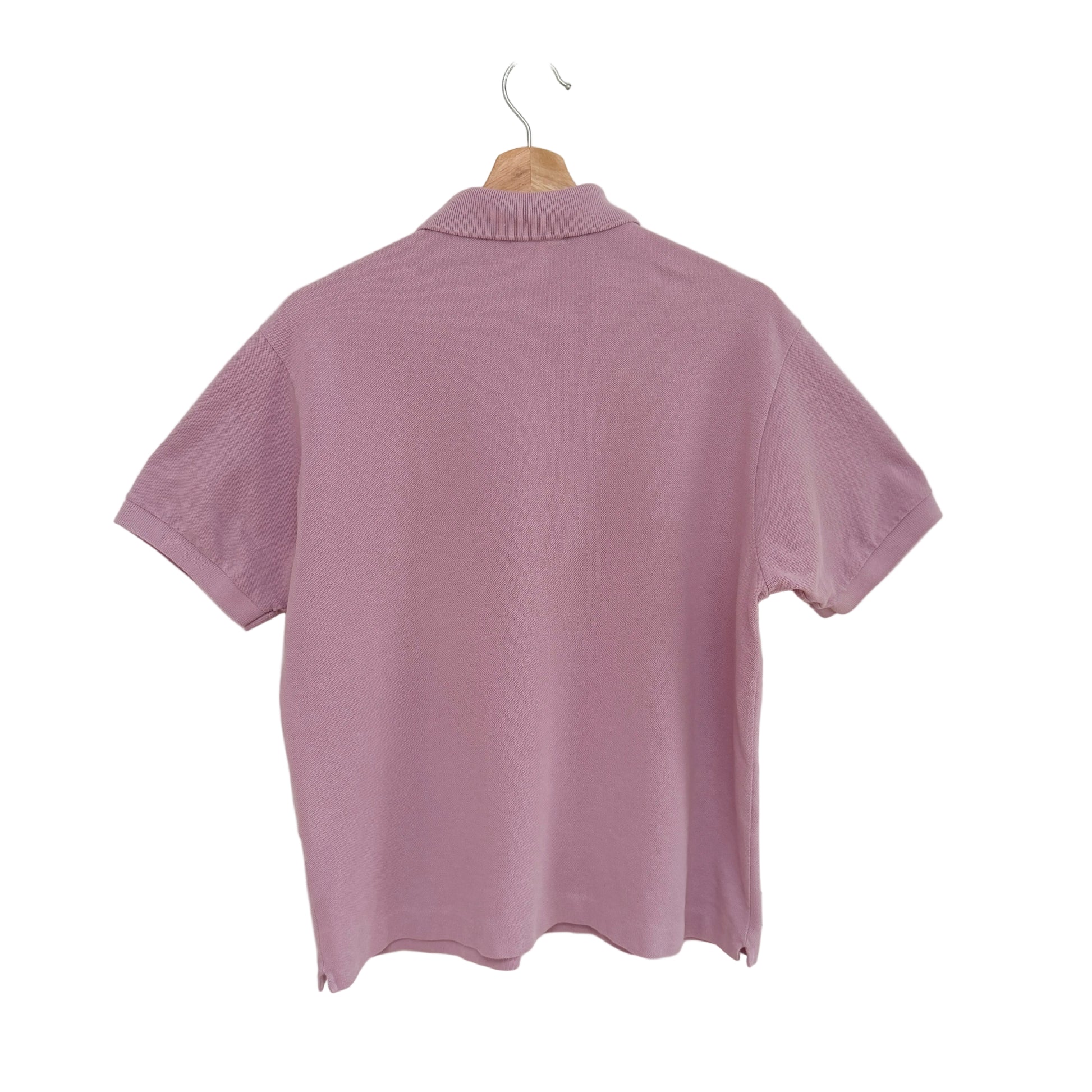 Lavender polo shirt on a hanger against a white background