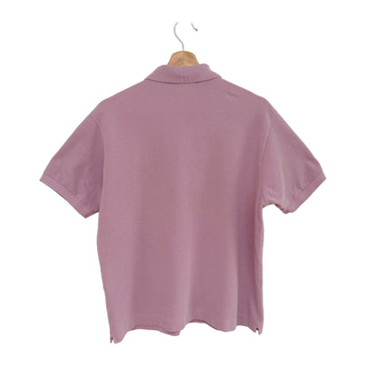 Lavender polo shirt on a hanger against a white background