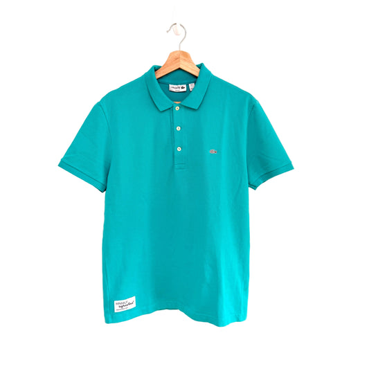 Teal polo shirt on a hanger against a white background