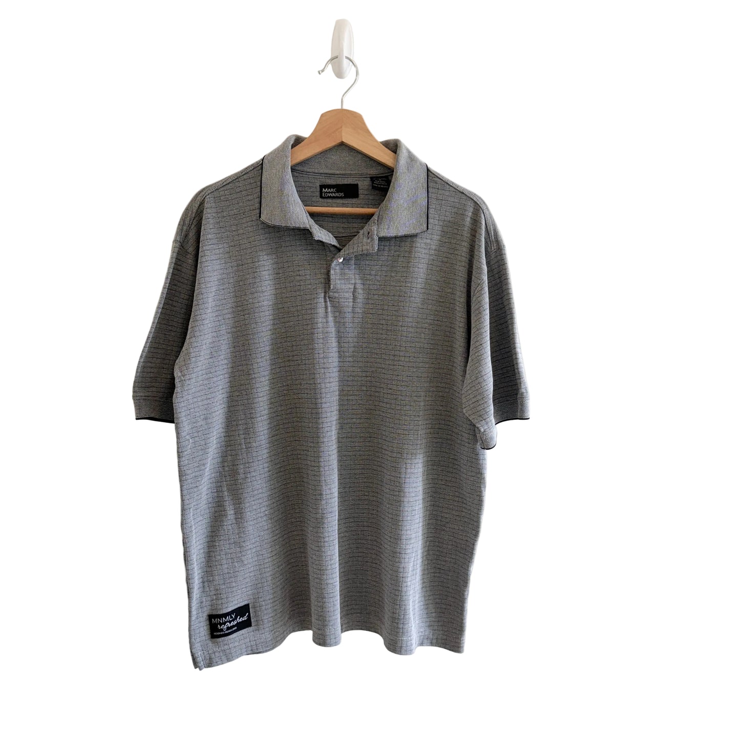 Gray polo shirt on a hanger against a white background
