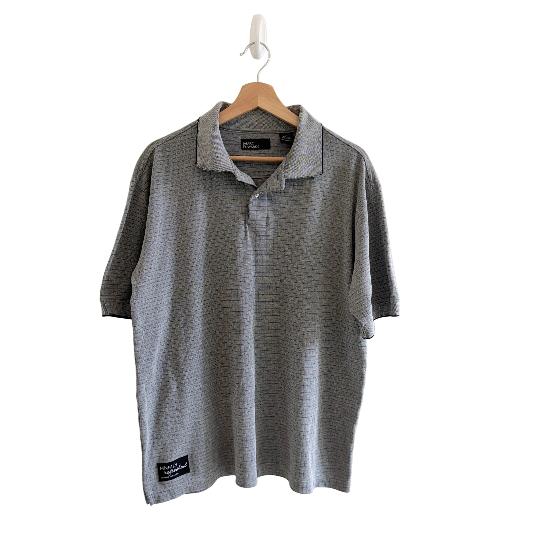 Gray polo shirt on a hanger against a white background