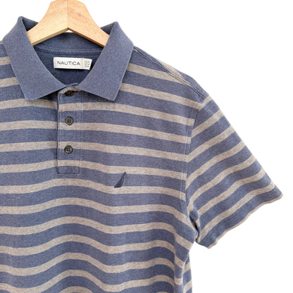 Blue and beige striped polo shirt on a hanger with Nautica label.