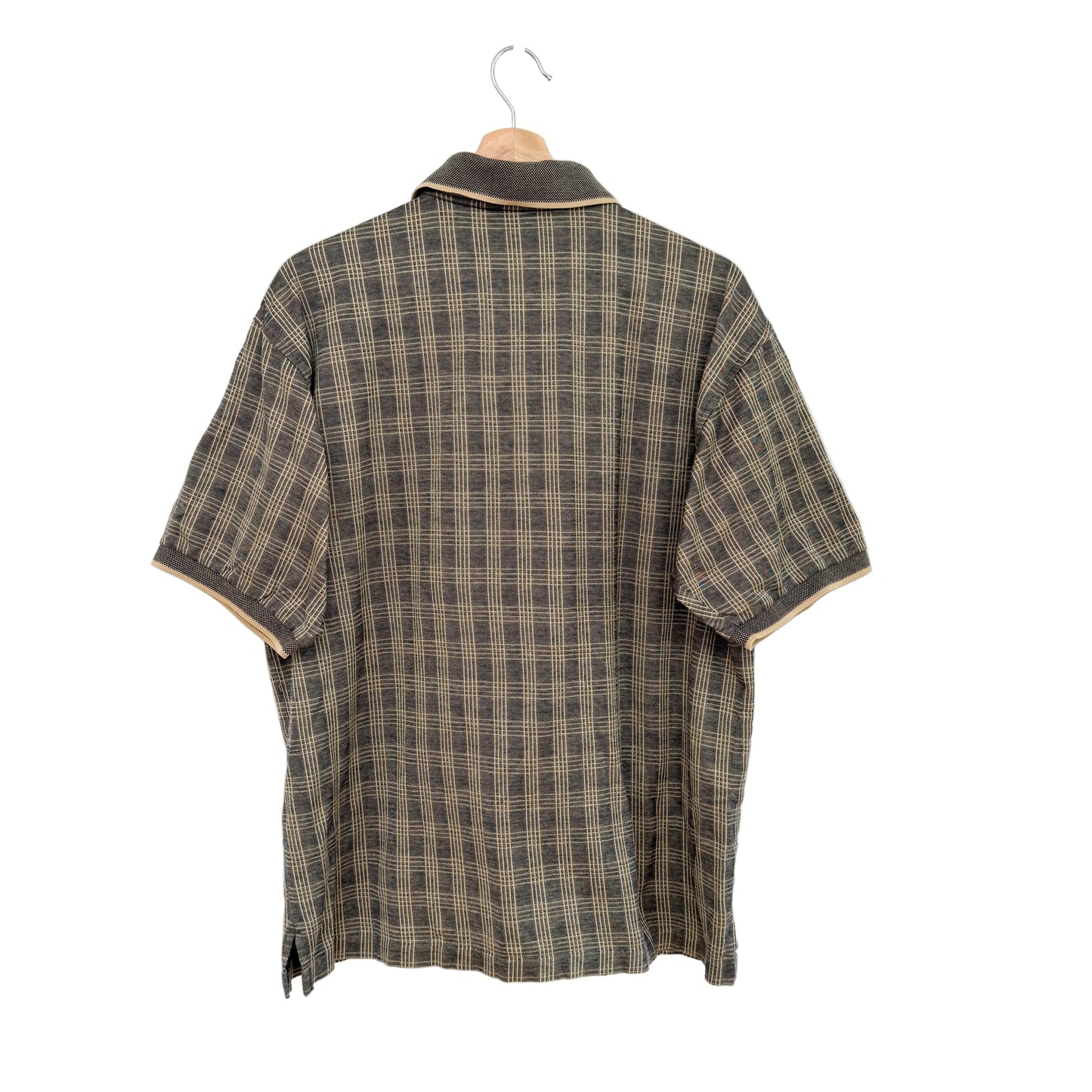 Plaid shirt on a hanger against a white background