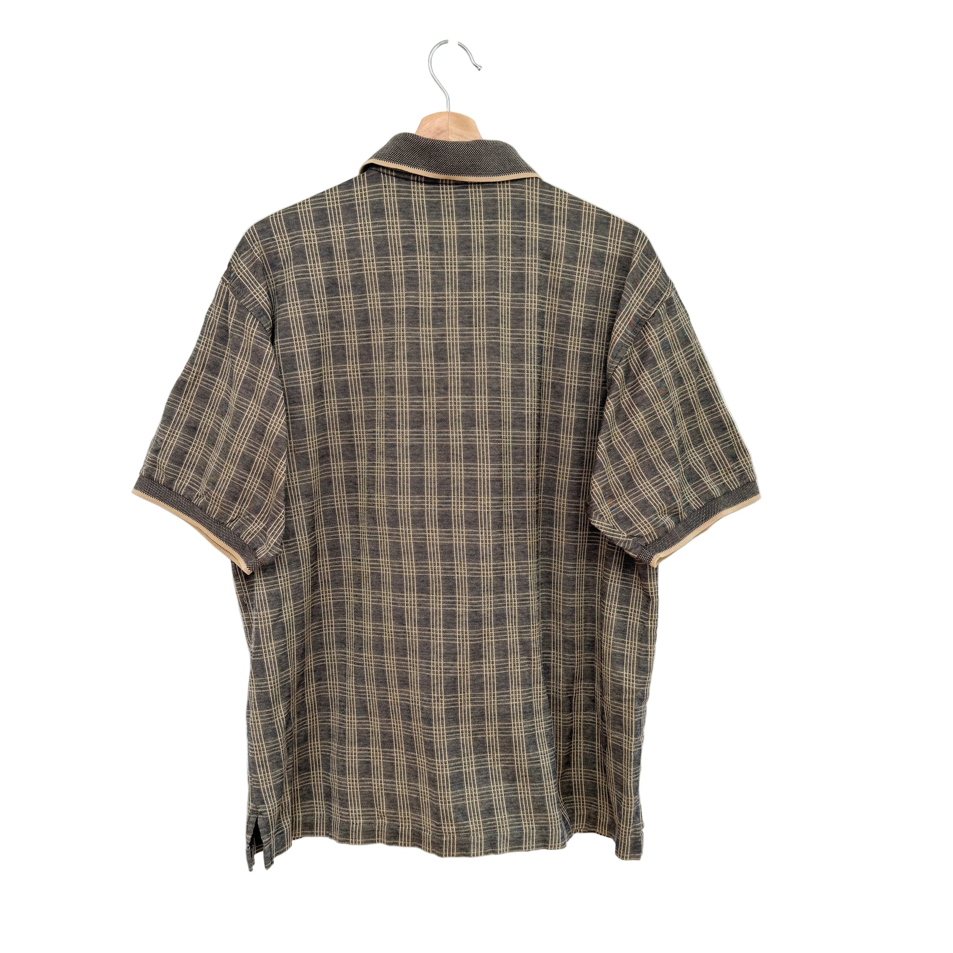 Plaid shirt on a hanger against a white background