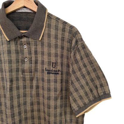 Plaid shirt with a brand logo on a hanger against a white background