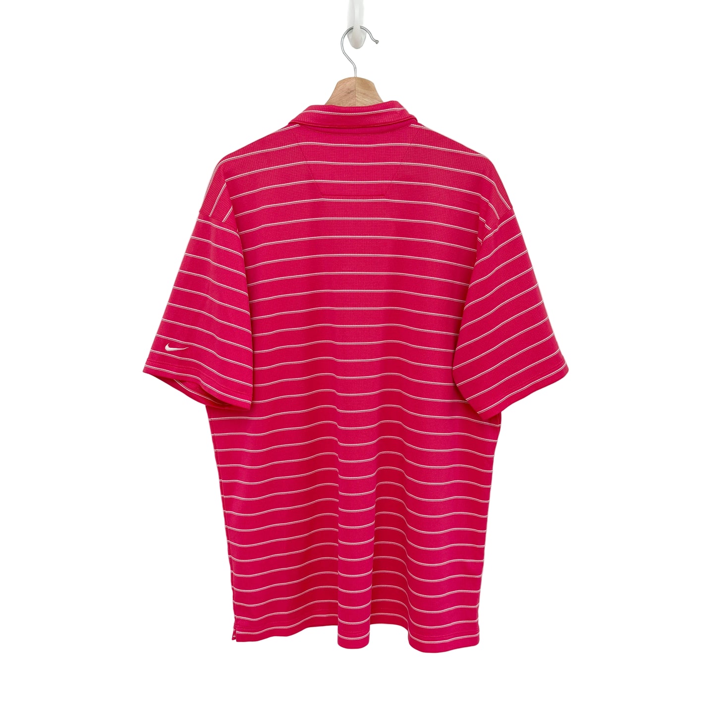 Pink and white striped polo shirt on a hanger against a white background