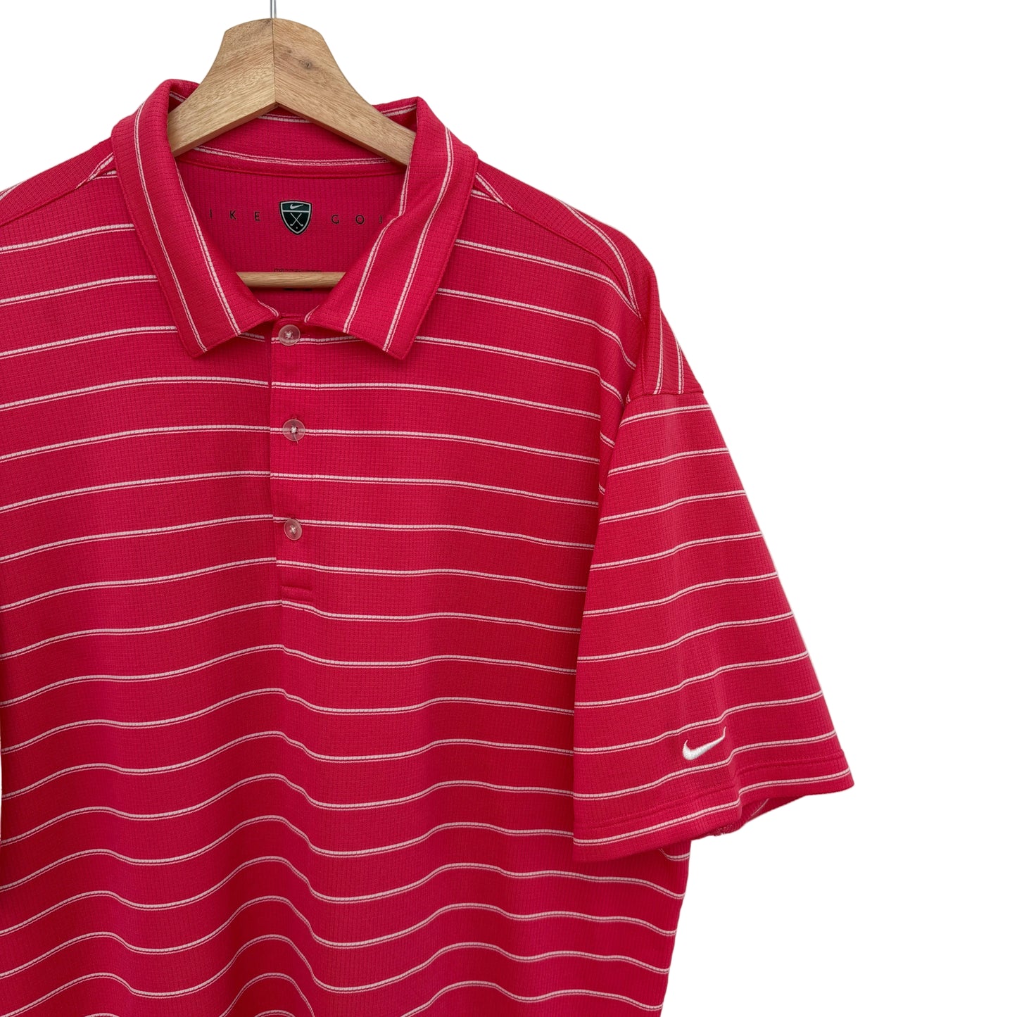 Pink striped polo shirt on a hanger against a white background