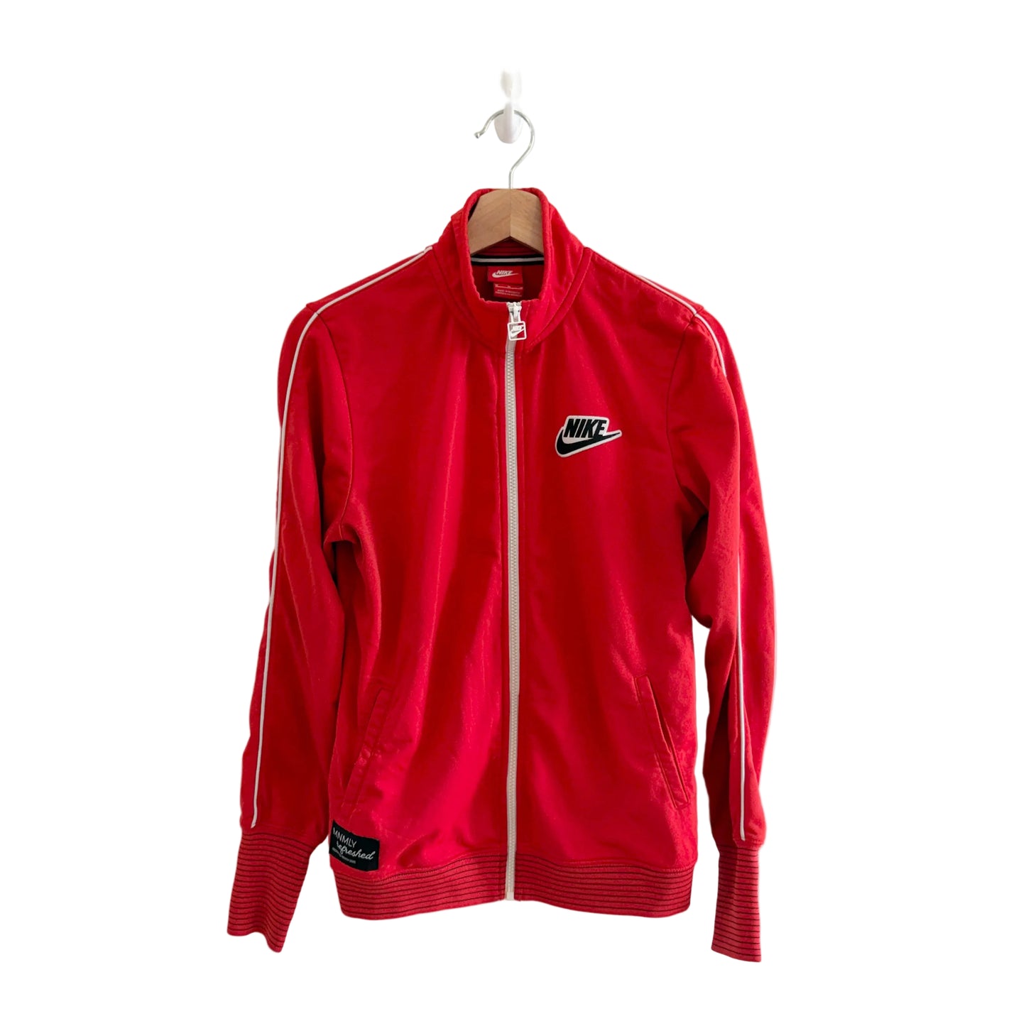 Red Nike tracksuit jacket on a hanger against a white background