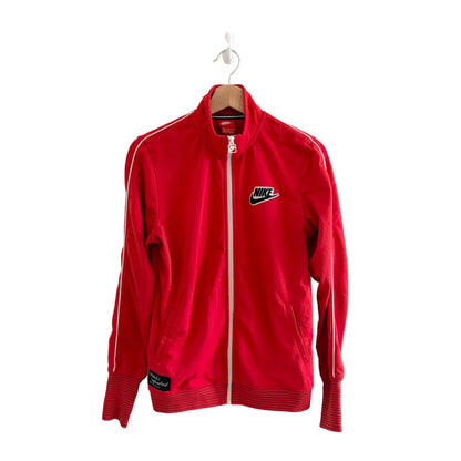 Red Nike tracksuit jacket on a hanger against a white background