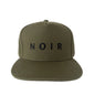 Green cap with 'NOIR' logo on a white background
