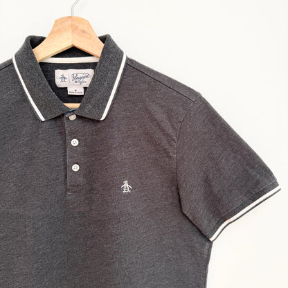 Gray polo shirt with white trim on a hanger against a white background
