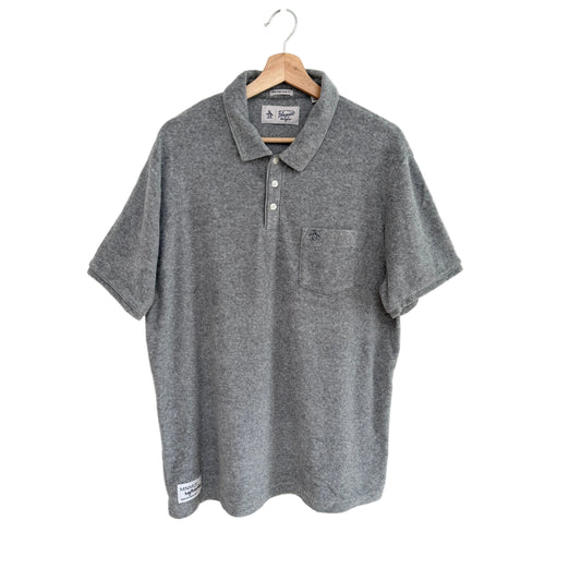 Gray polo shirt on a hanger against a white background