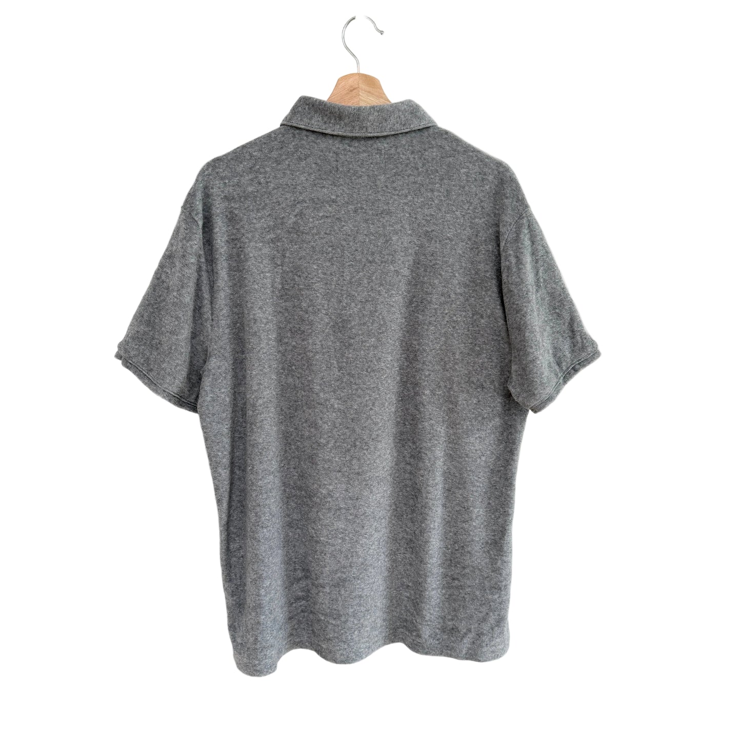 Gray polo shirt on a hanger against a white background