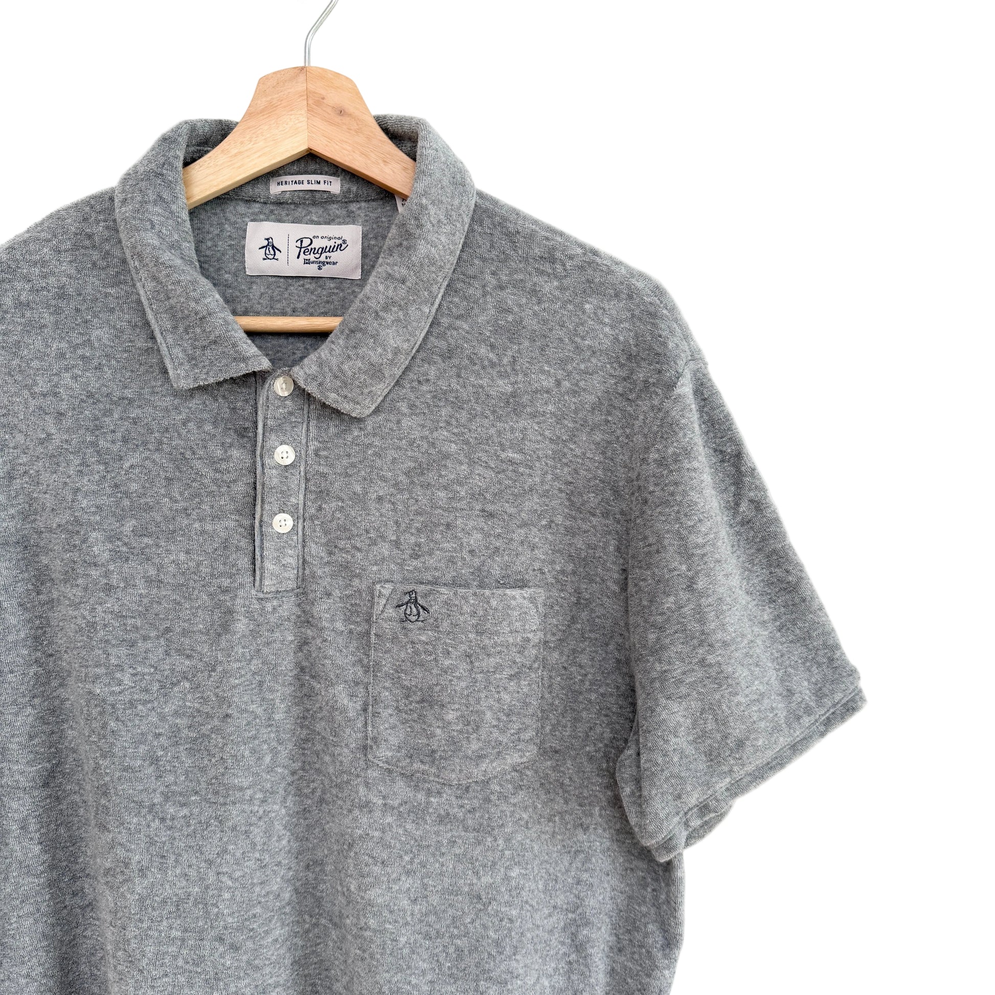 Gray polo shirt on a hanger against a white background