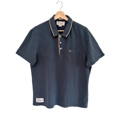 Navy blue polo shirt on a hanger against a white background