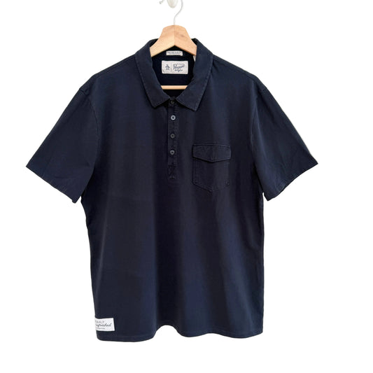 Navy blue polo shirt on a hanger against a white background