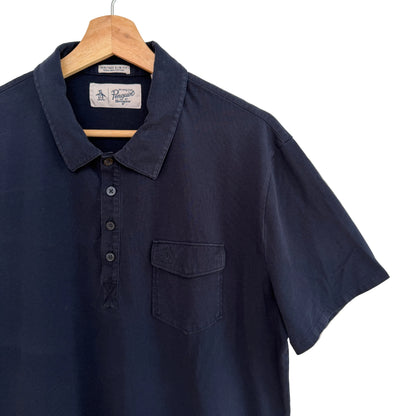 Navy blue short-sleeve shirt on a hanger against a white background