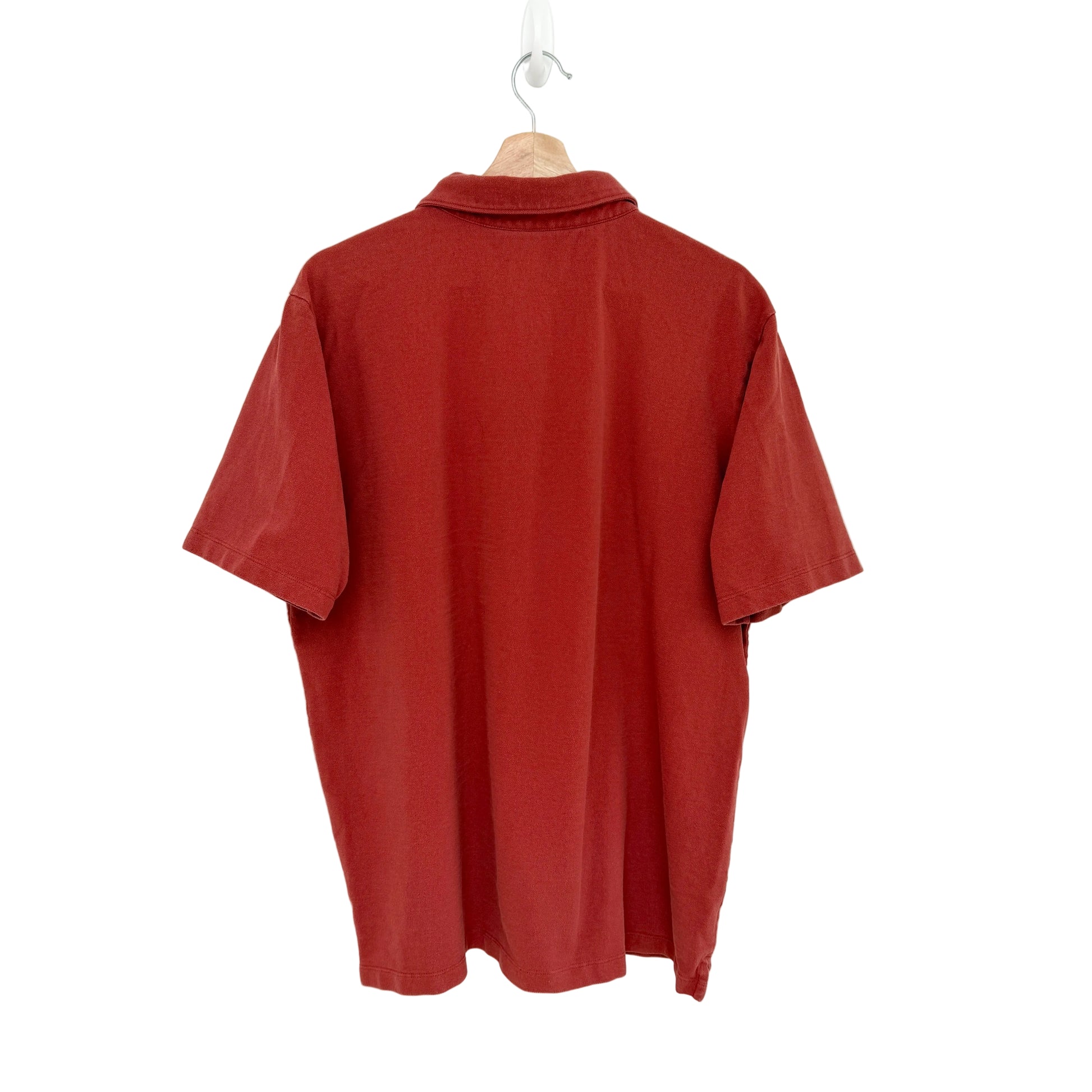 Red shirt on a hanger against a white background