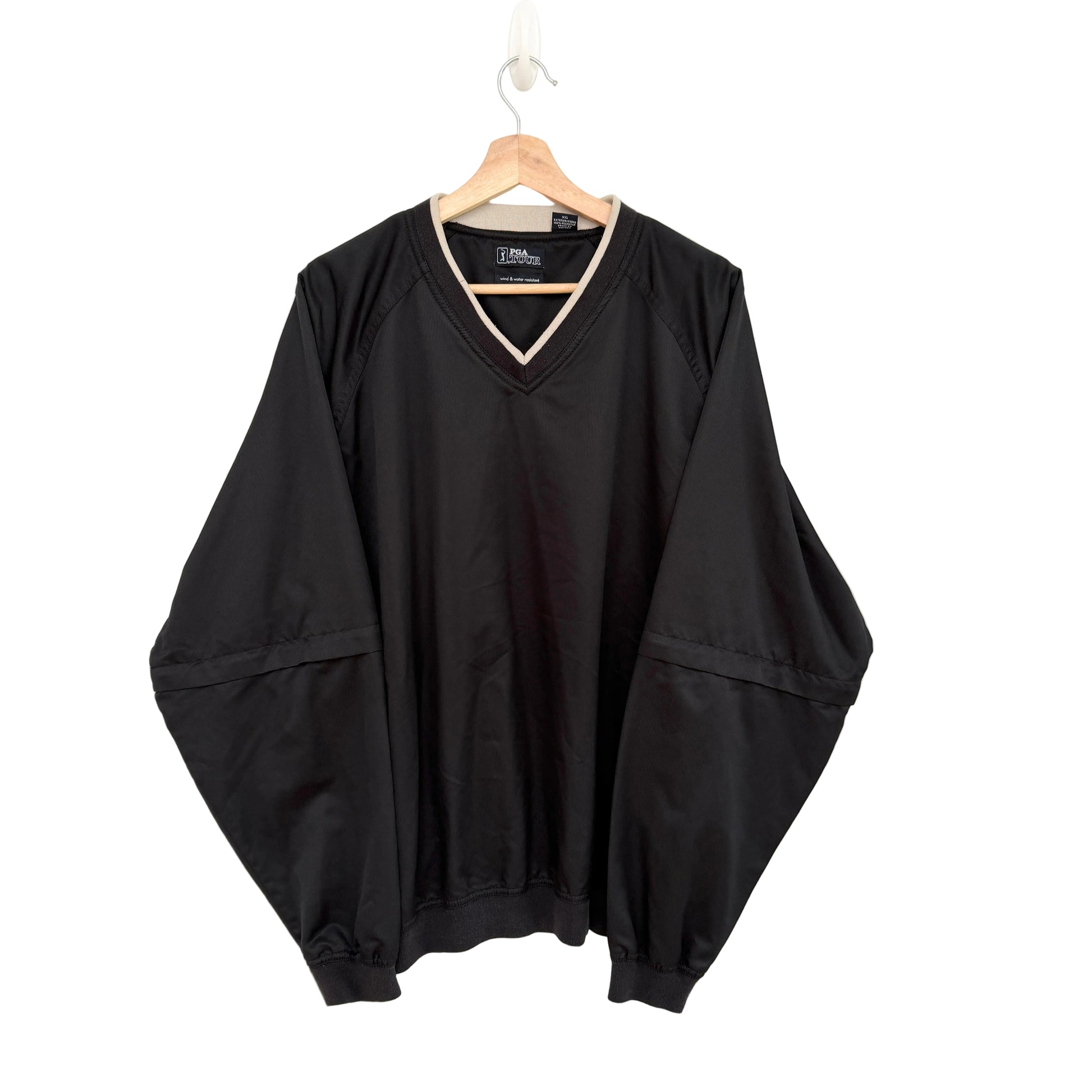 Black oversized sweater on a hanger against a white background
