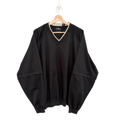 Black oversized sweater on a hanger against a white background