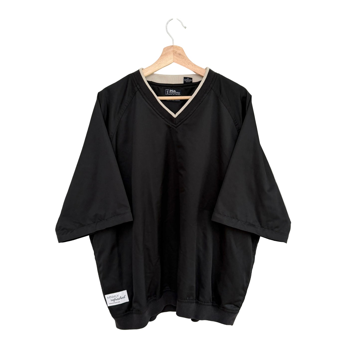 Black shirt on a hanger against a white background