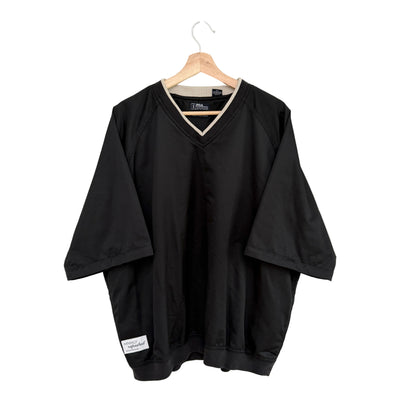 Black shirt on a hanger against a white background