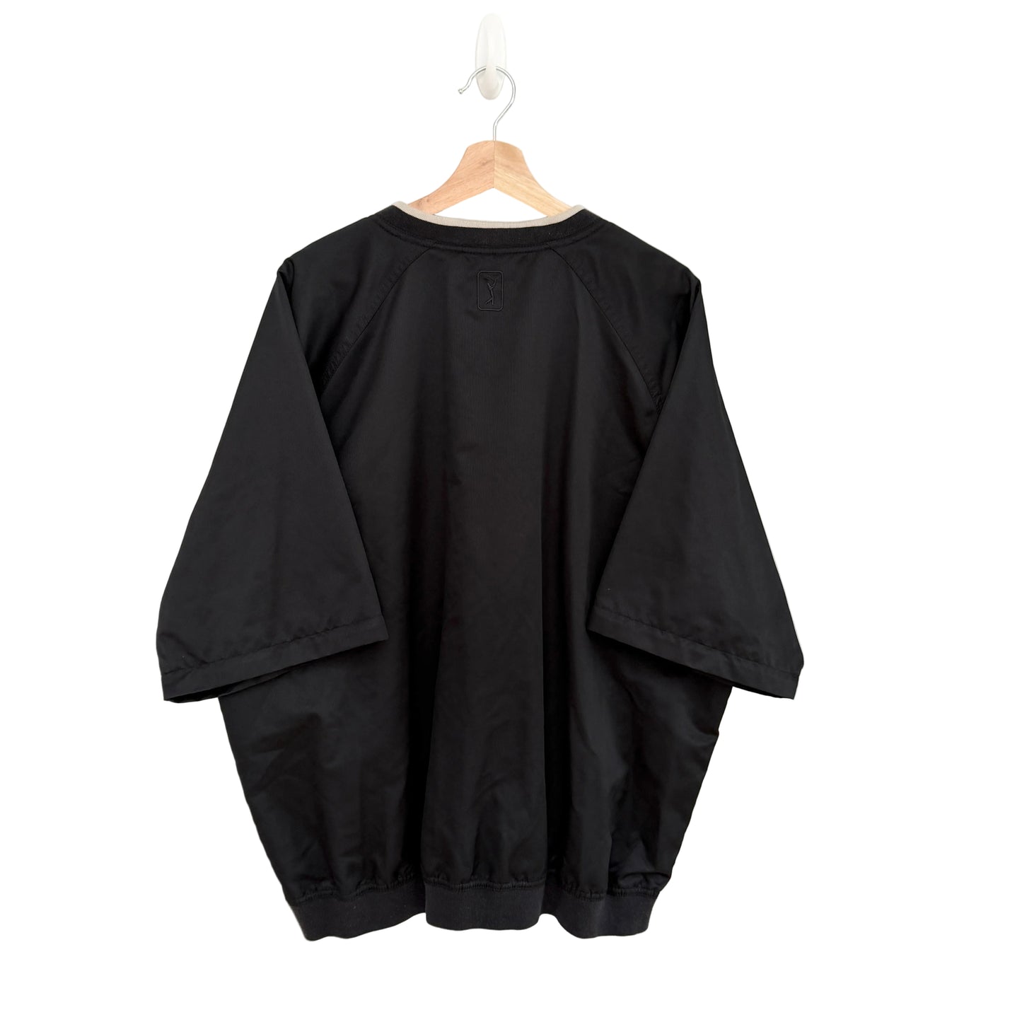 Black oversized shirt on a hanger against a white background