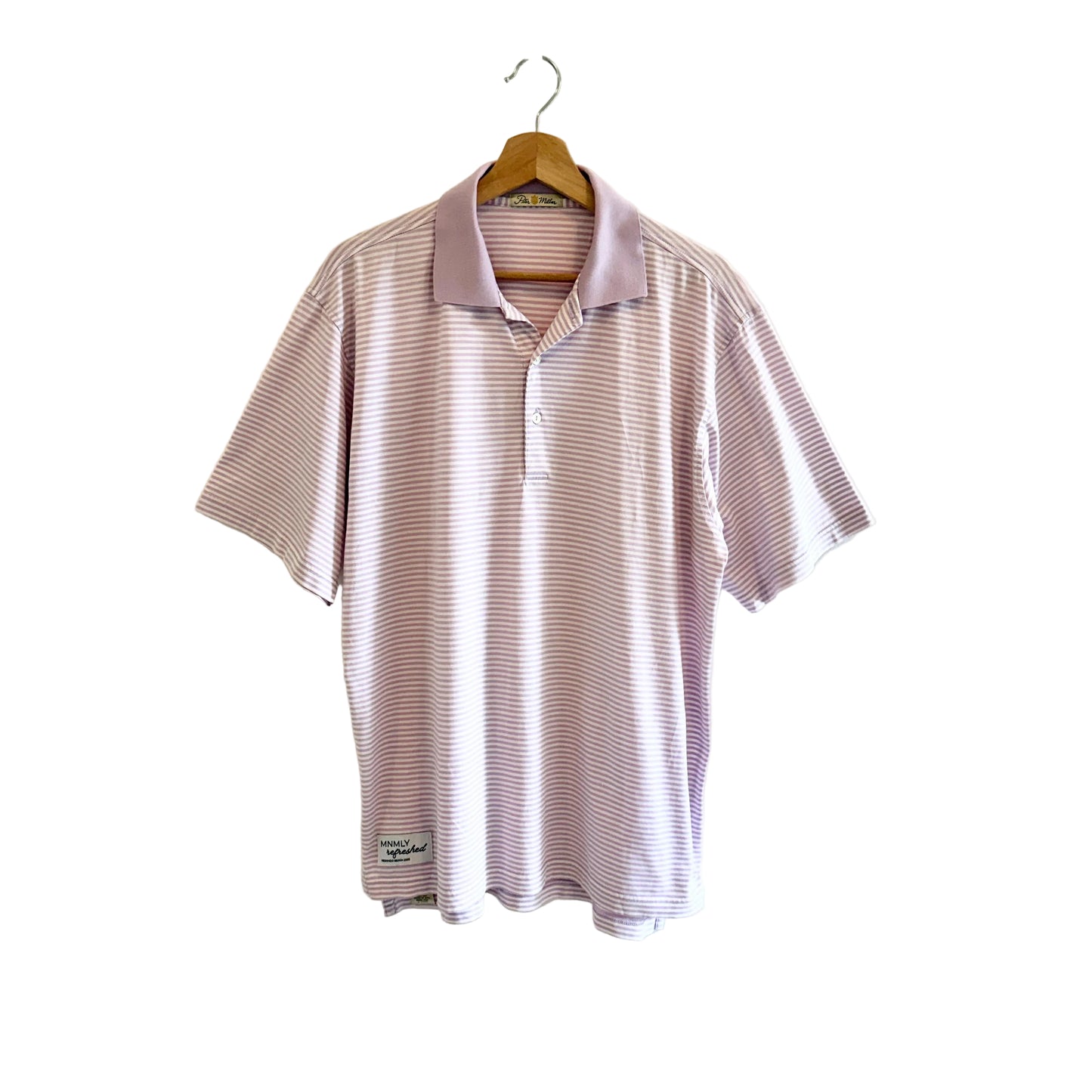 Striped polo shirt on a hanger against a plain background