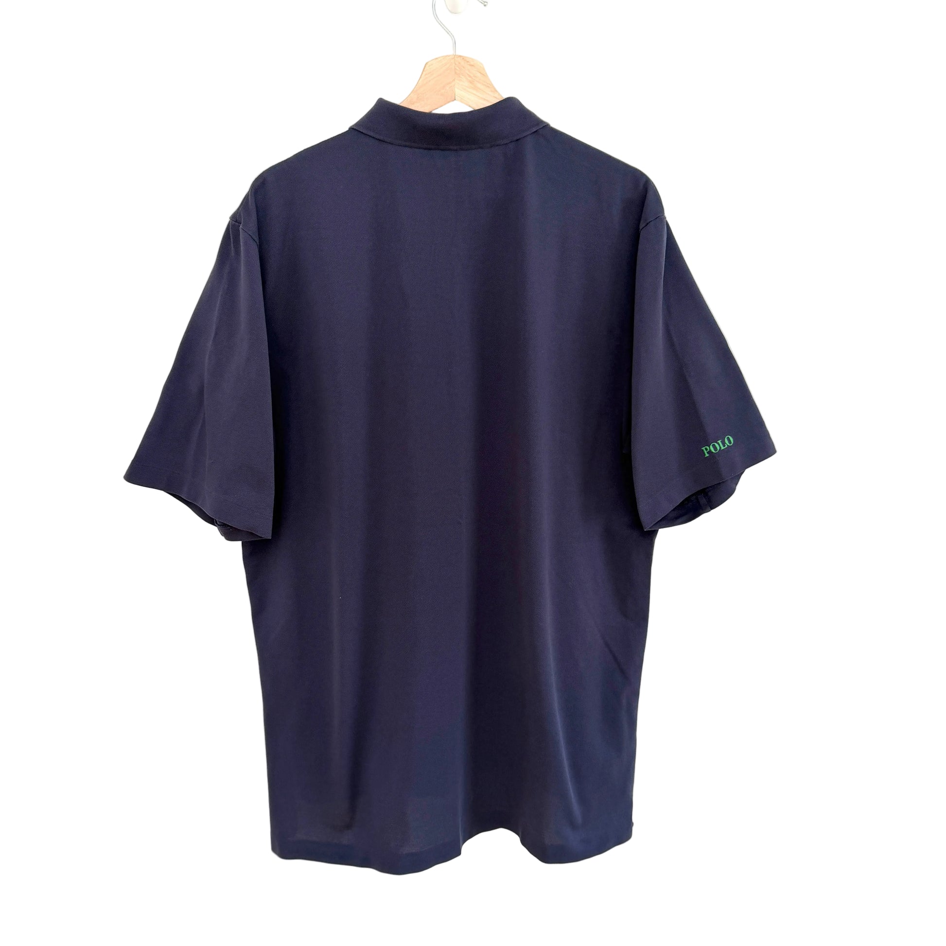 Navy blue polo shirt on a hanger with 'Polo' branding.