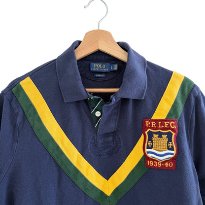 Navy blue polo shirt with colorful collar and P.R.L.F.C. patch on a hanger.