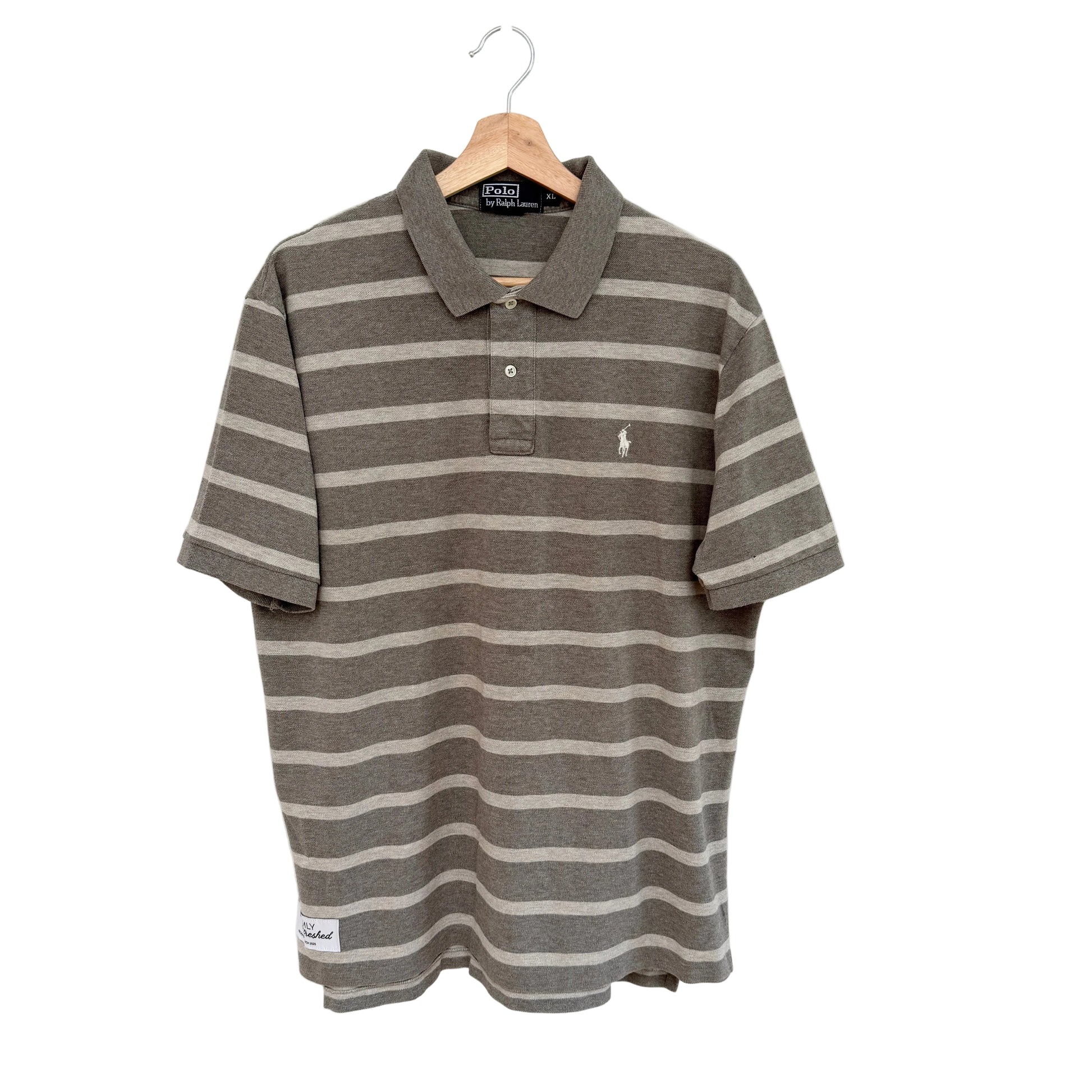 Tan striped polo shirt on a hanger against a white background
