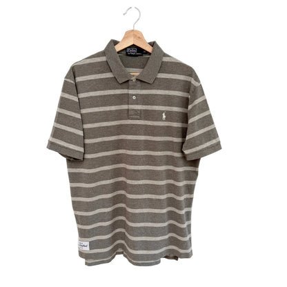 Tan striped polo shirt on a hanger against a white background
