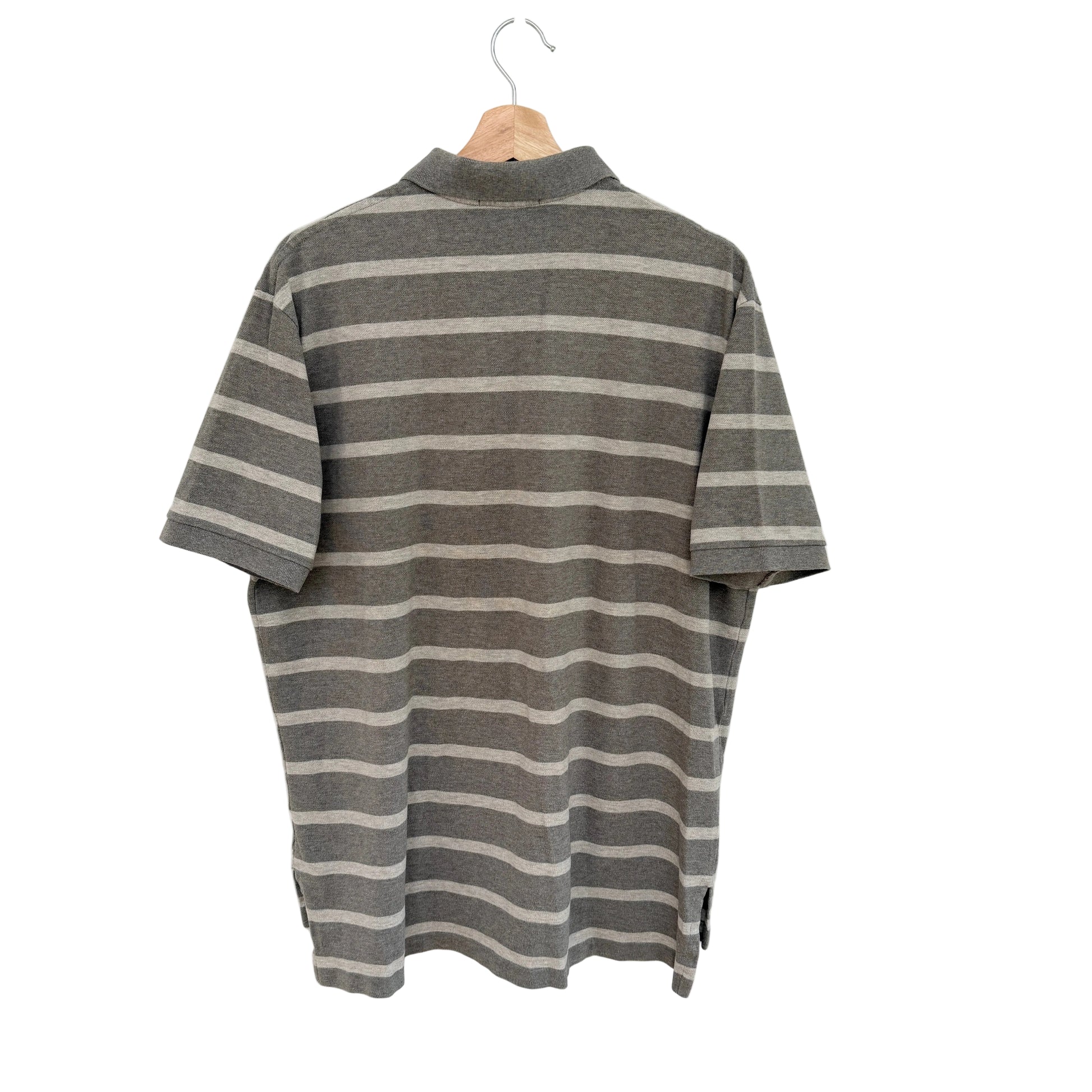 Tan striped shirt on a hanger against a white background
