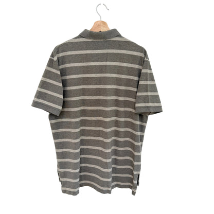 Tan striped shirt on a hanger against a white background