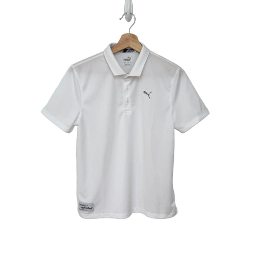 White polo shirt with a brand logo on a hanger against a gray background