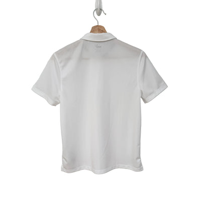 White polo shirt on a hanger against a gray background