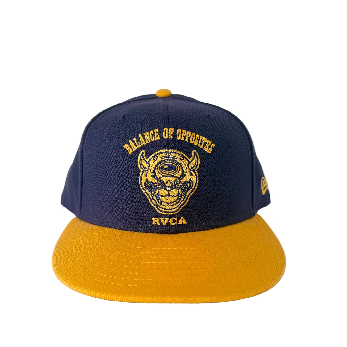Navy and yellow cap with RVCA logo on a white background
