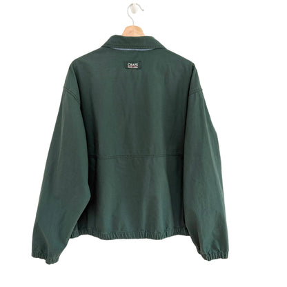 Green jacket on a hanger with a visible brand logo against a white background