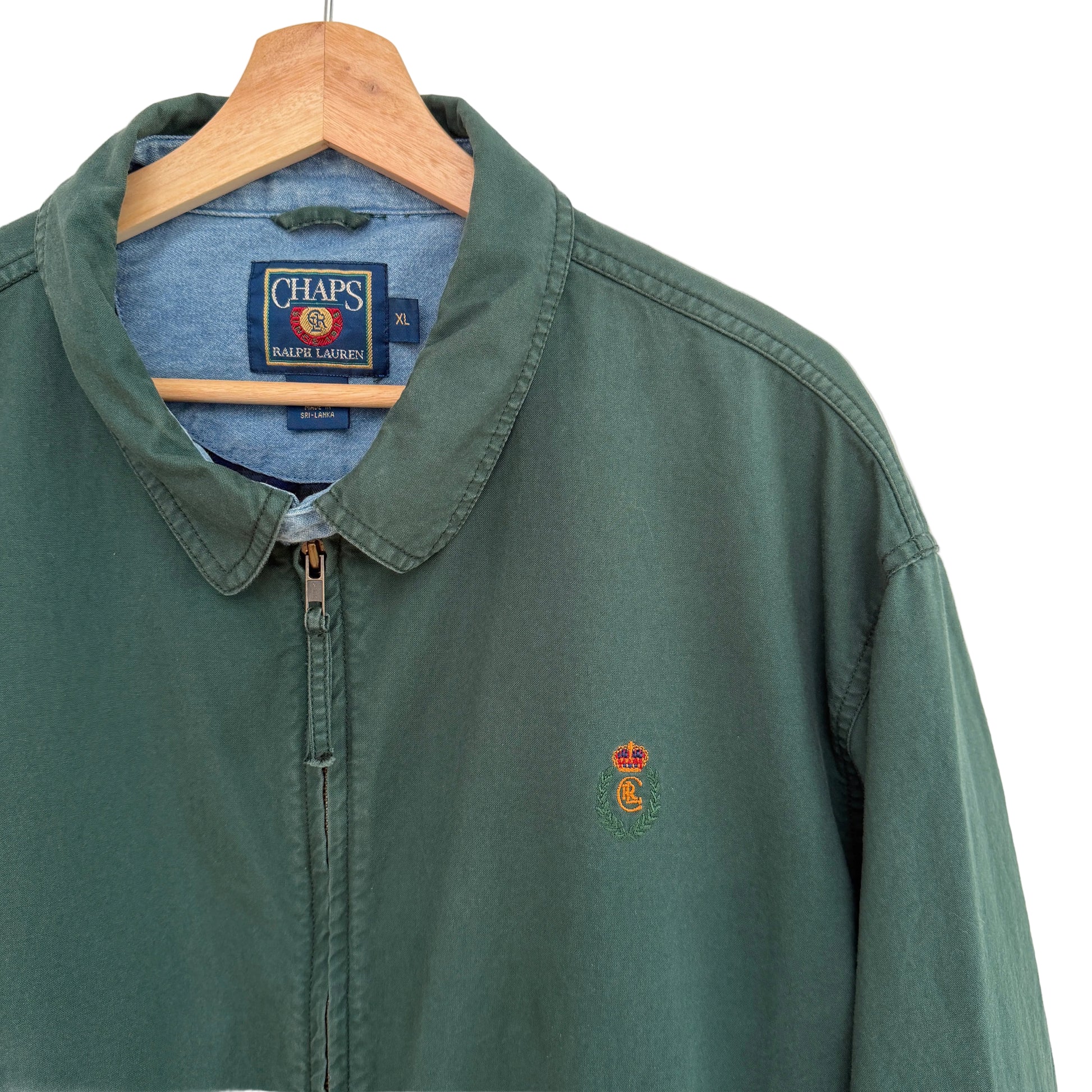 Green jacket with a logo on a hanger against a white background