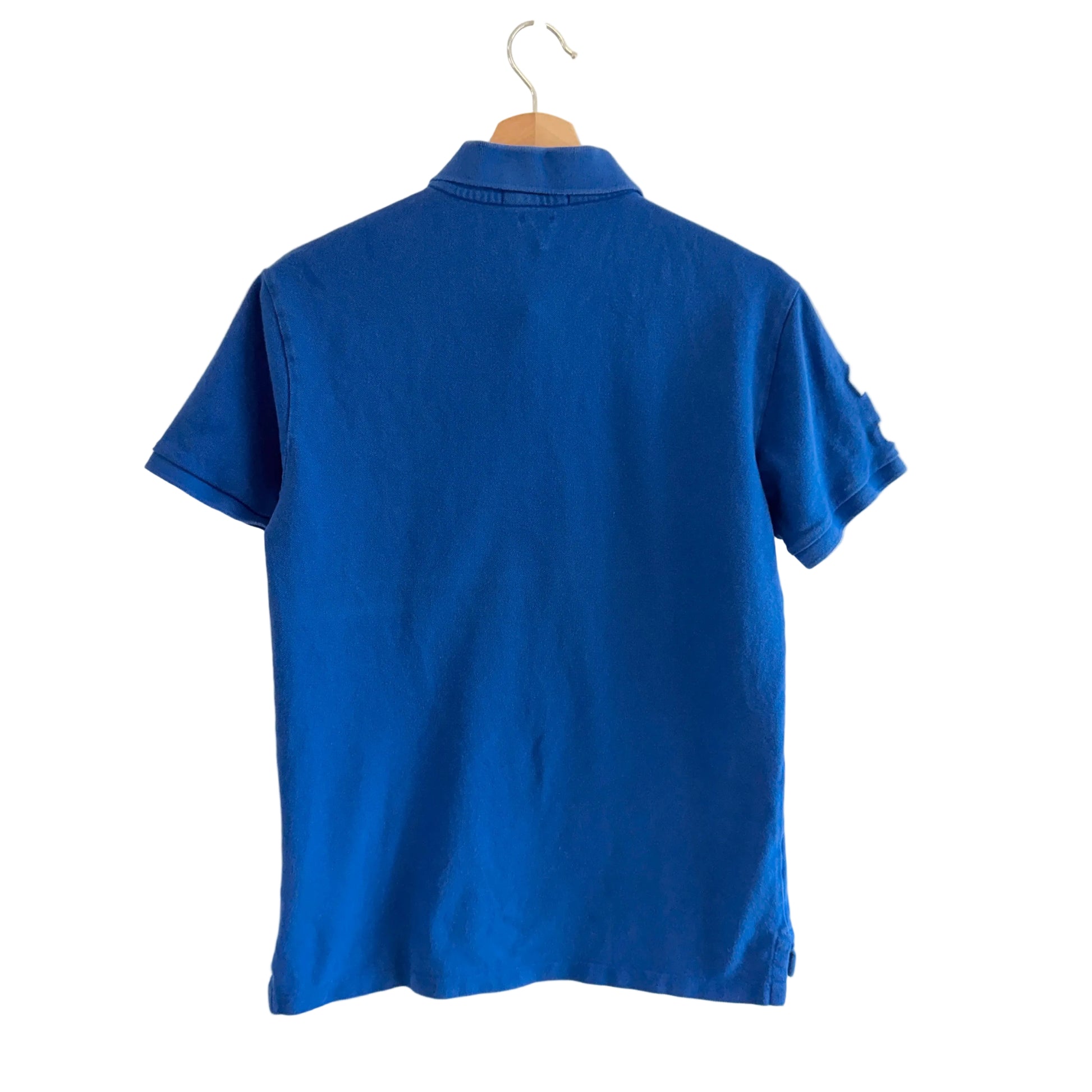 Blue polo shirt on a hanger against a white background