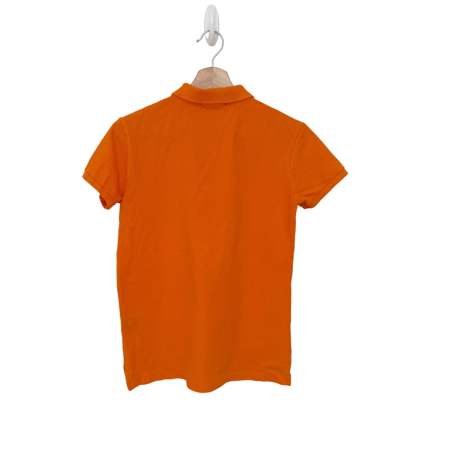 Orange polo shirt on a hanger against a white background