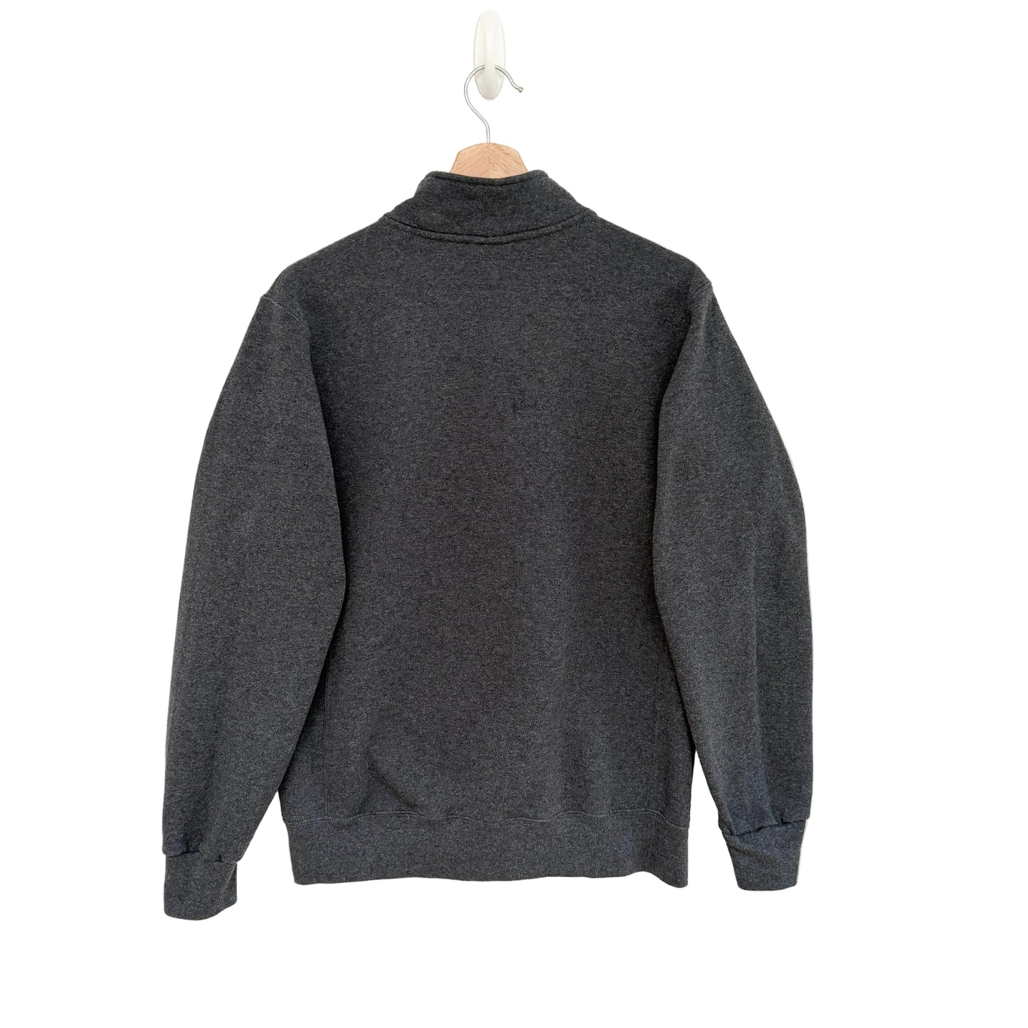Gray sweater on a hanger against a white background