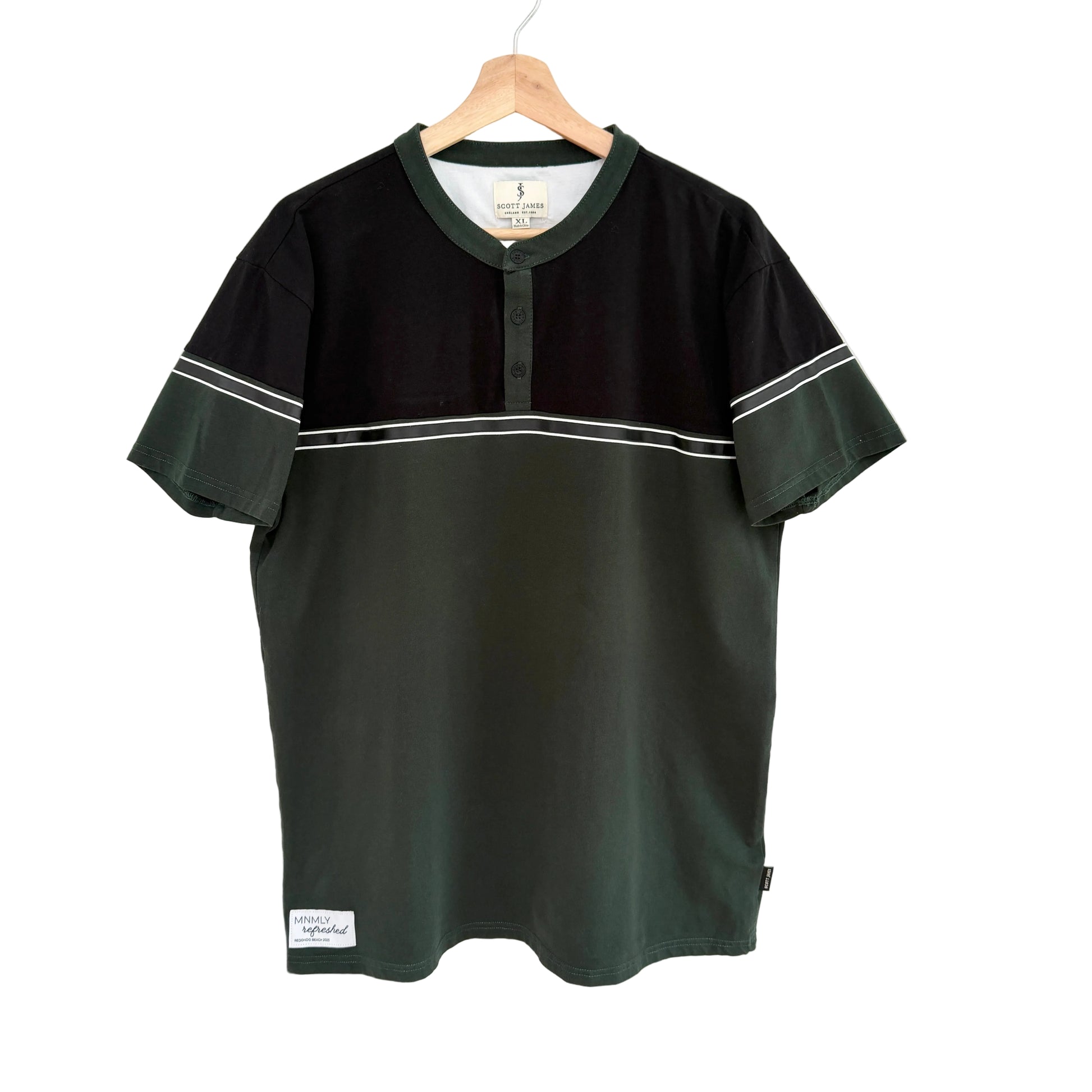 Black and green baseball jersey on a hanger against a white background