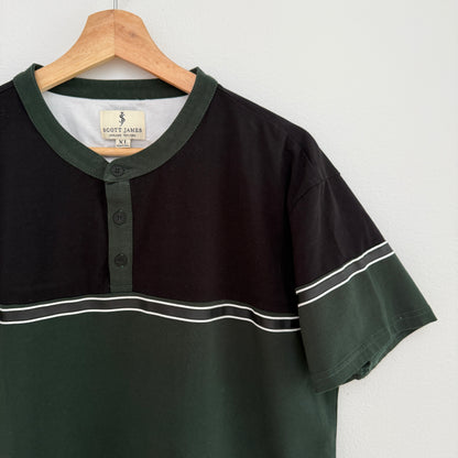 Black and green polo shirt on a hanger with a white background